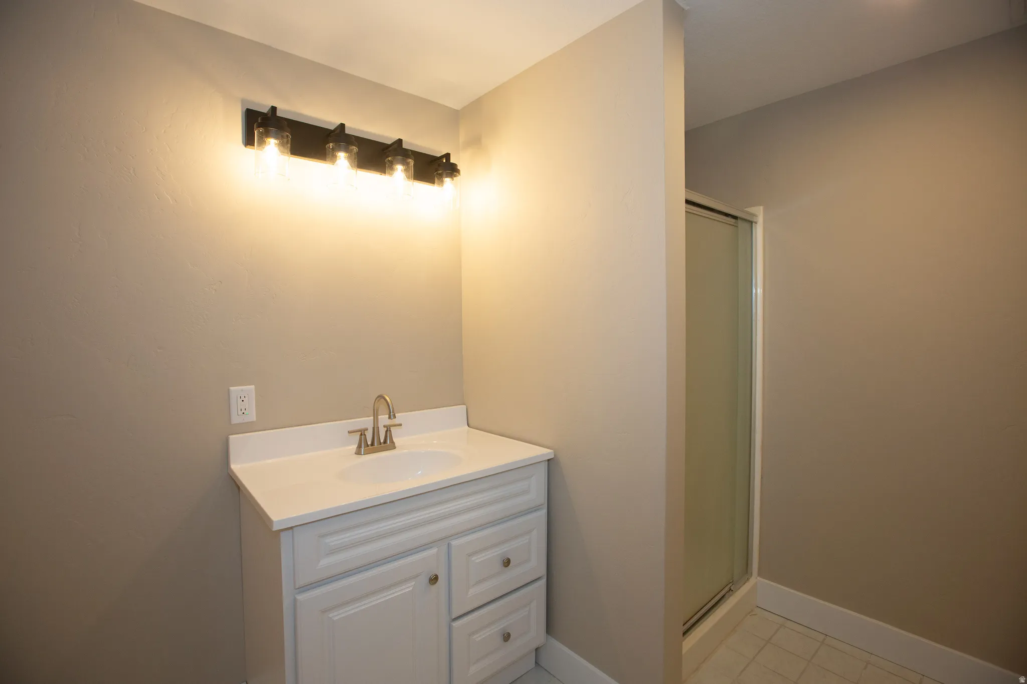Updated bathroom with vanity and a shower stall