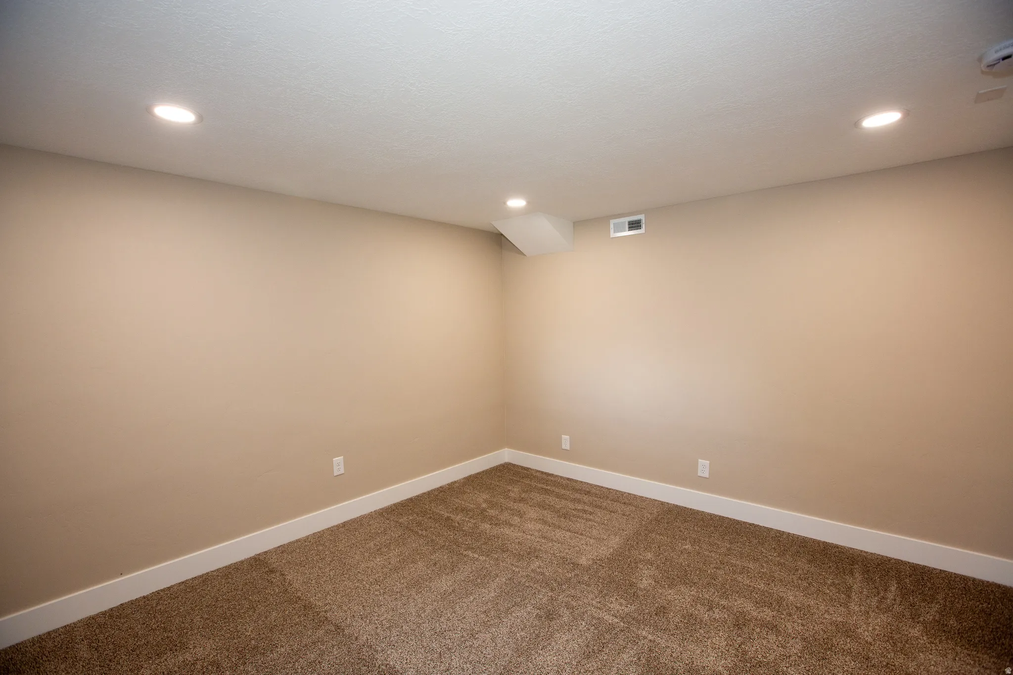 Large bedroom 3 featuring dark colored carpet, recessed lighting