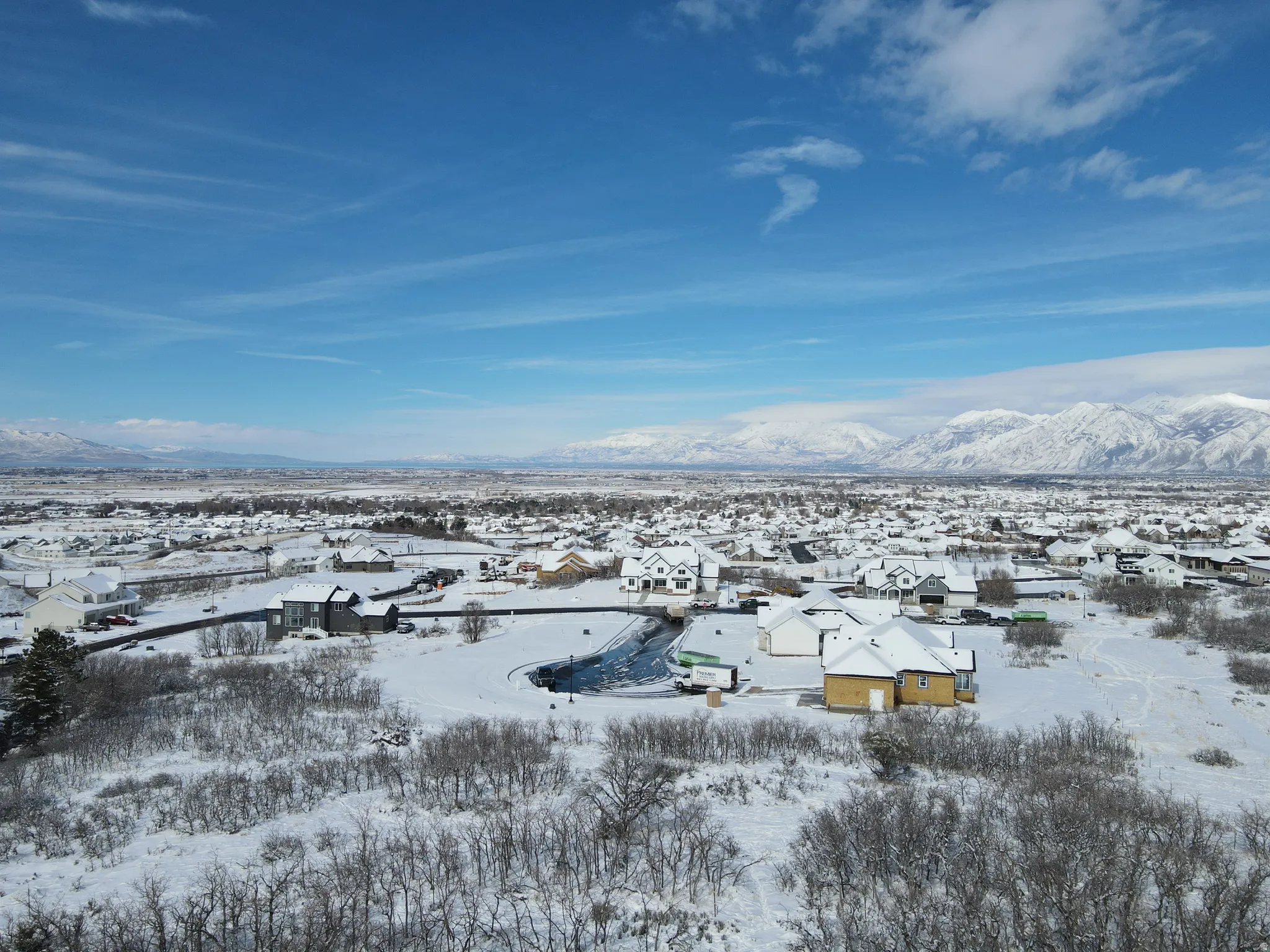 Snowy aerial view featuring a residential view and a mountain view