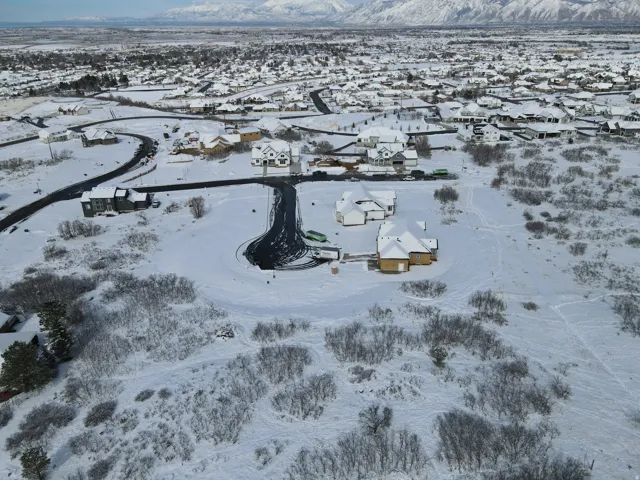 Snowy aerial view with a residential view and a mountain view
