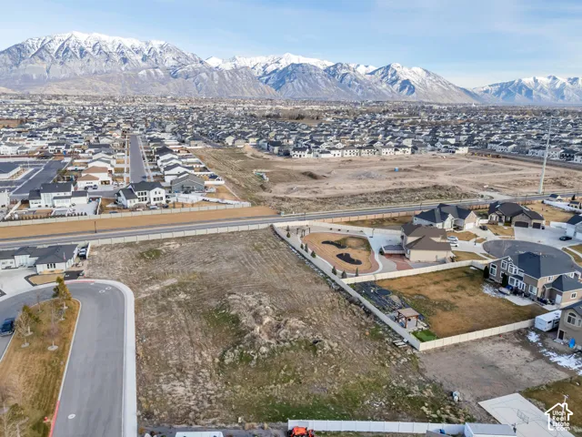 Aerial view of property's location with nearby suburban area and a mountain backdrop