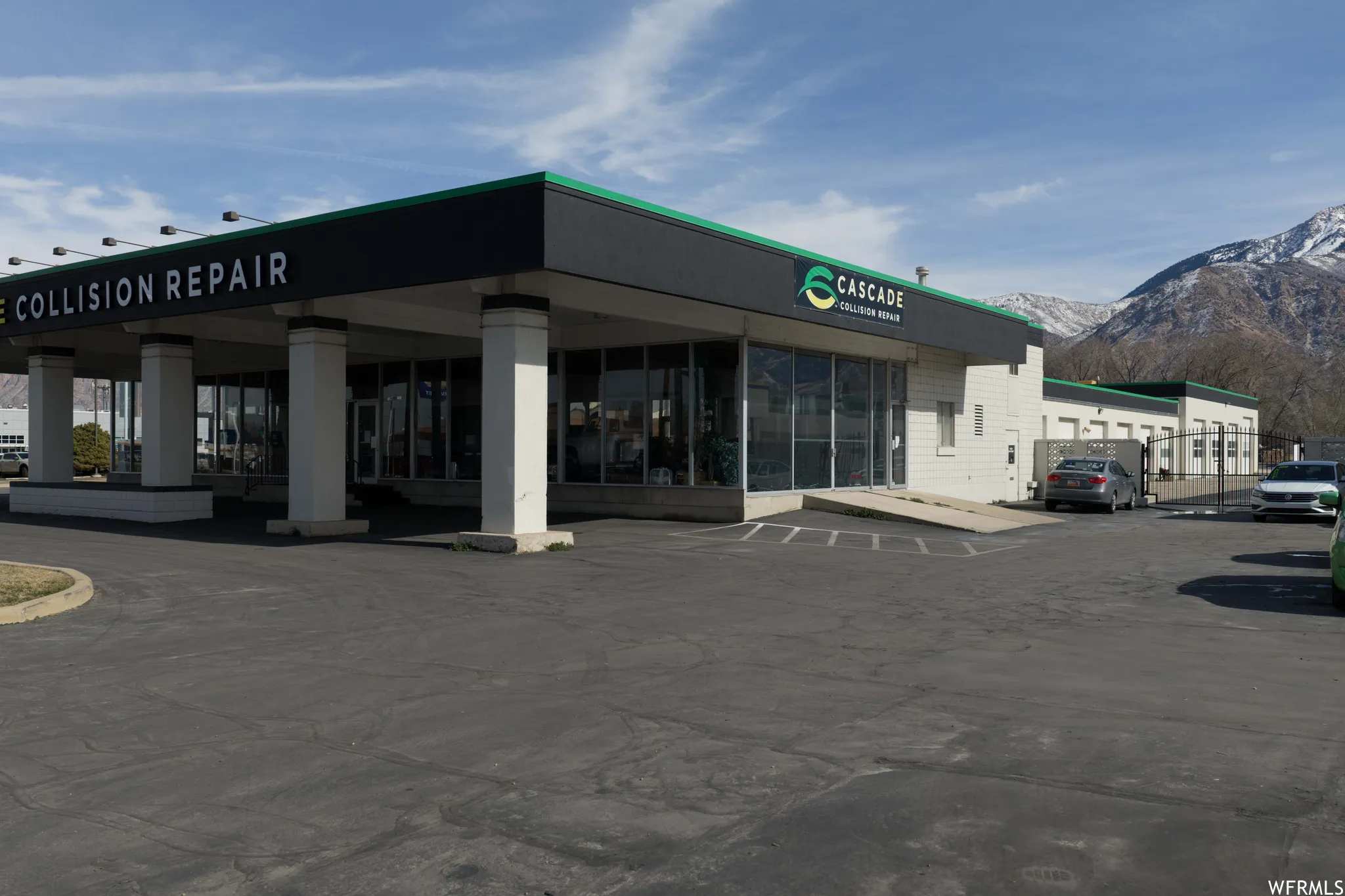 View of commercial property with uncovered parking