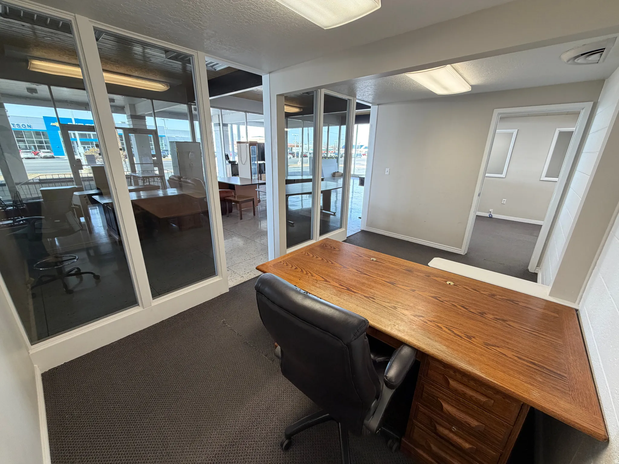 Office area with a textured ceiling and dark carpet