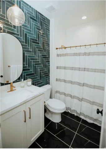 Full bathroom featuring vanity, a shower with shower curtain, dark tile patterned flooring, wallpapered walls, and recessed lighting