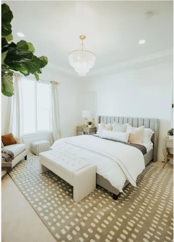 Carpeted bedroom featuring a chandelier