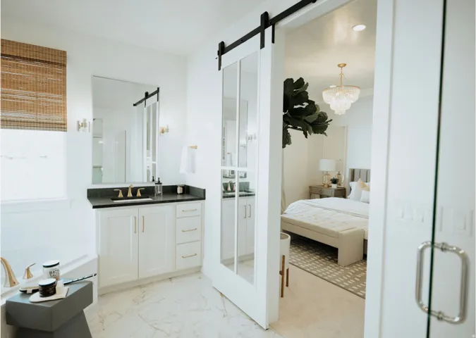 Full bath with ensuite bathroom, vanity, a garden tub, light marble finish floors, and a stall shower