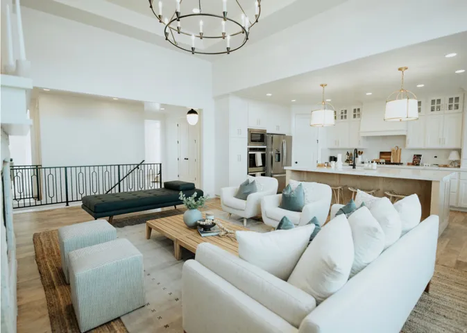 Living area featuring light wood-style flooring and hanging lights