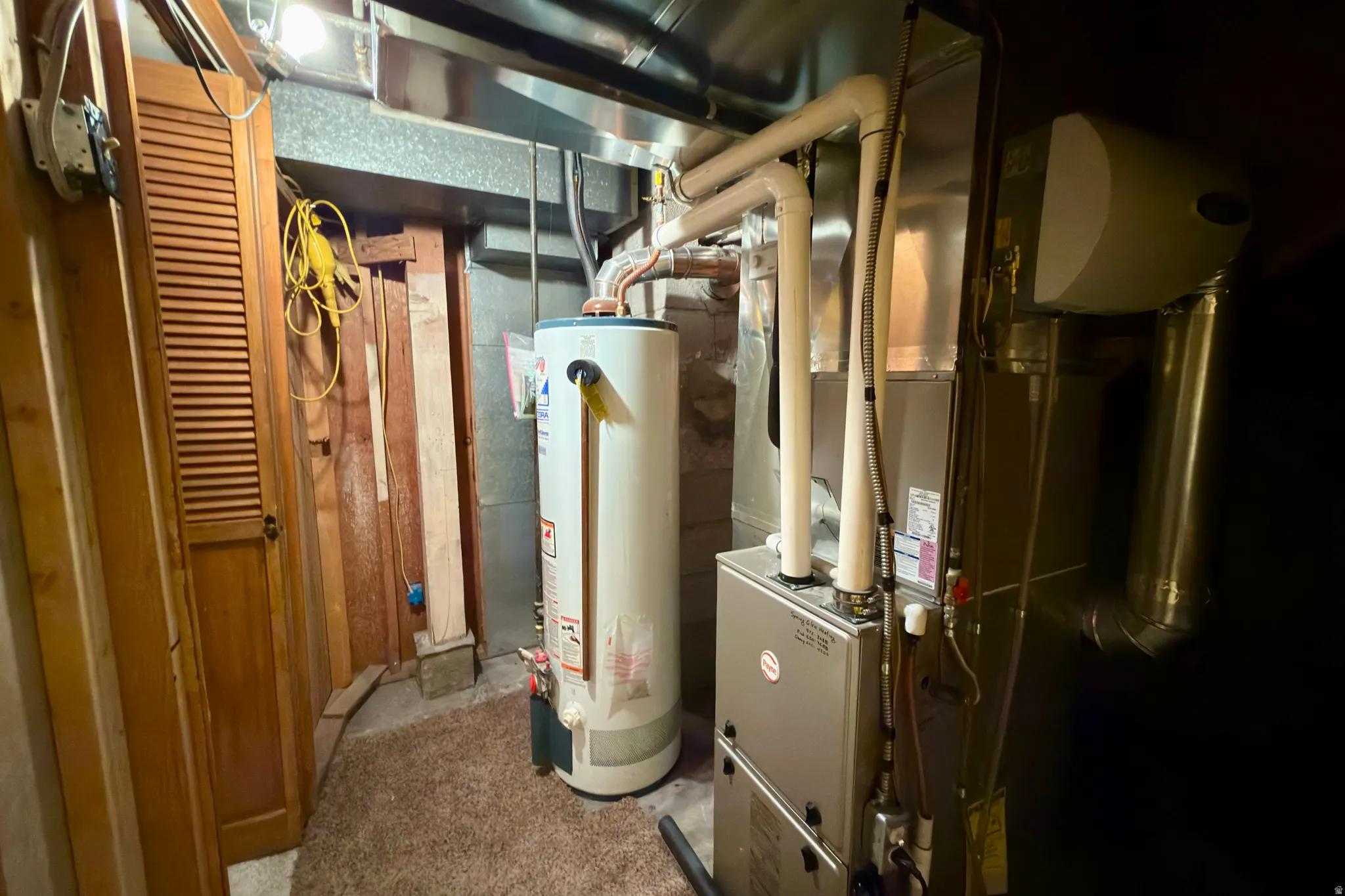 Basement utility closet with water heater and high efficiency furnace and AC.