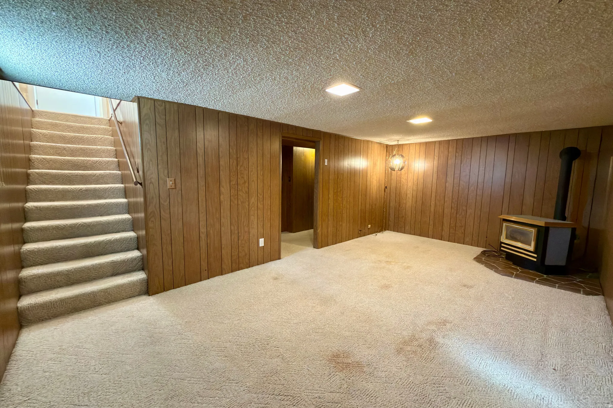 Basement family room with gas stove.