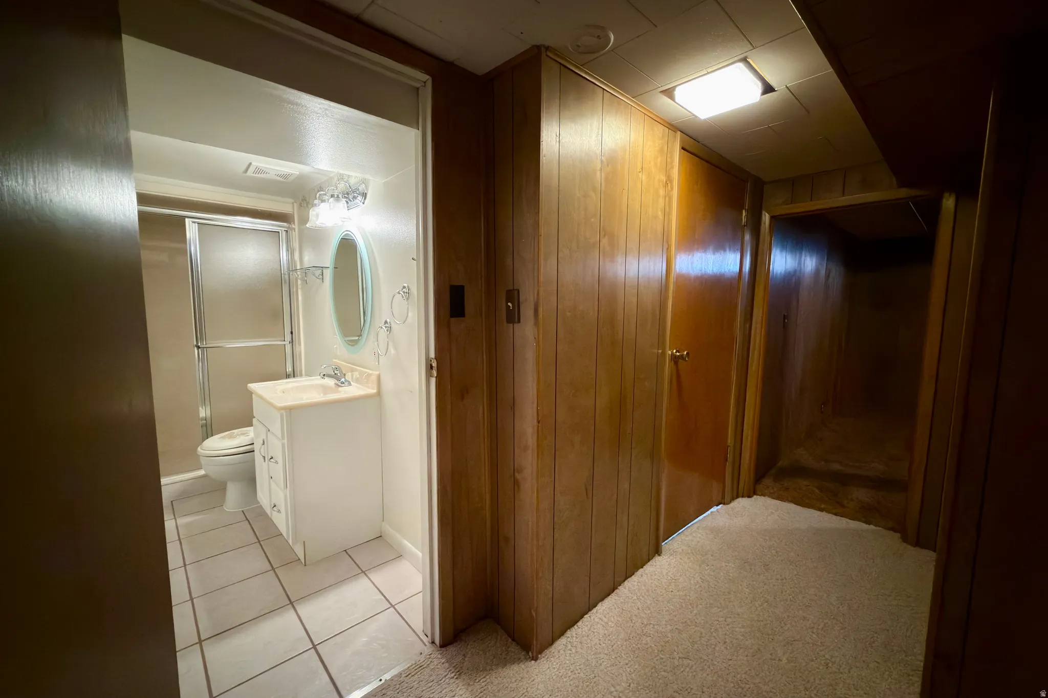 Basement hallway to 3/4 bath and bedroom.