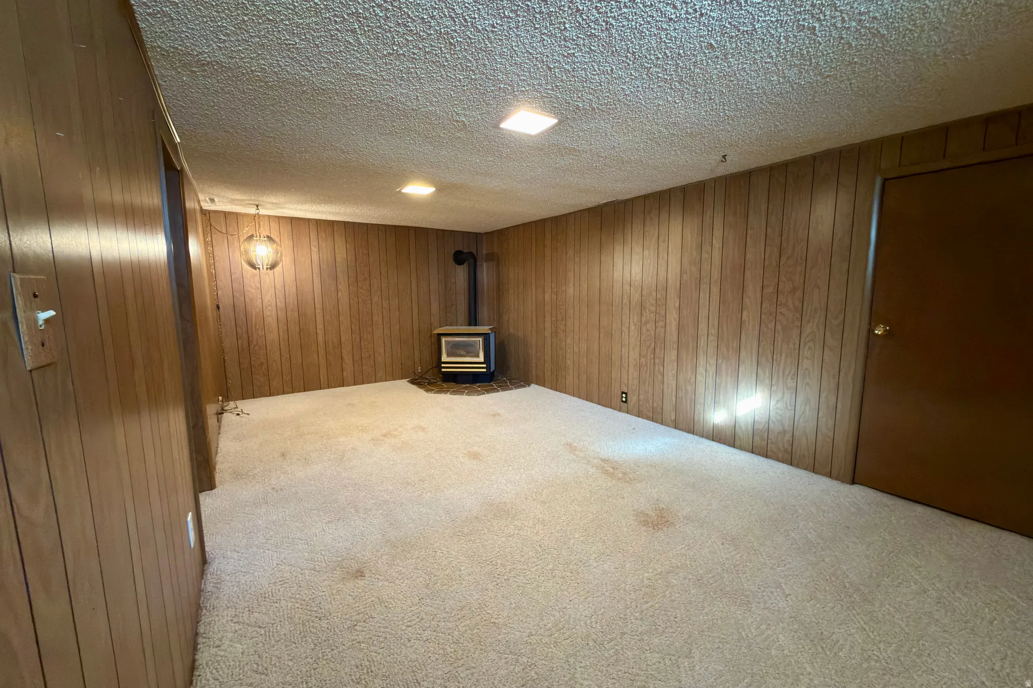 Basement family room with gas stove.