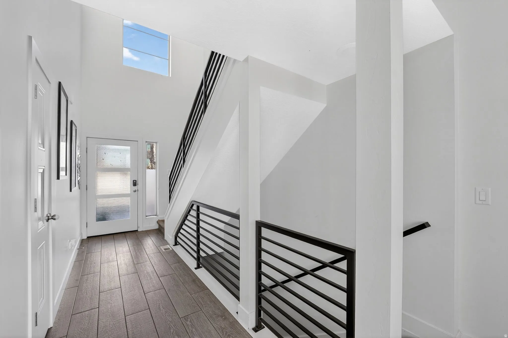 Entrance foyer with wood tiled floors and stairway