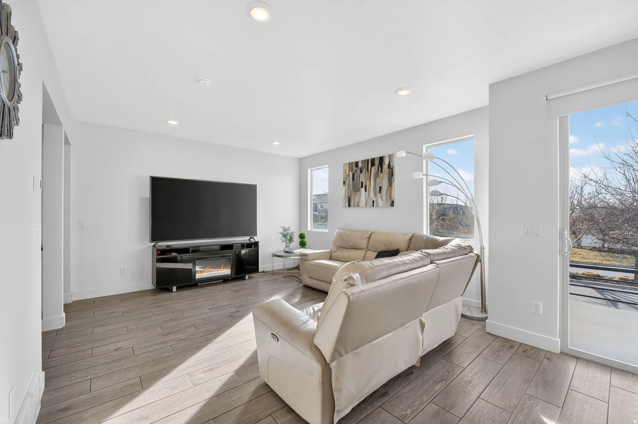 Living room with wood tiled floors and recessed lighting