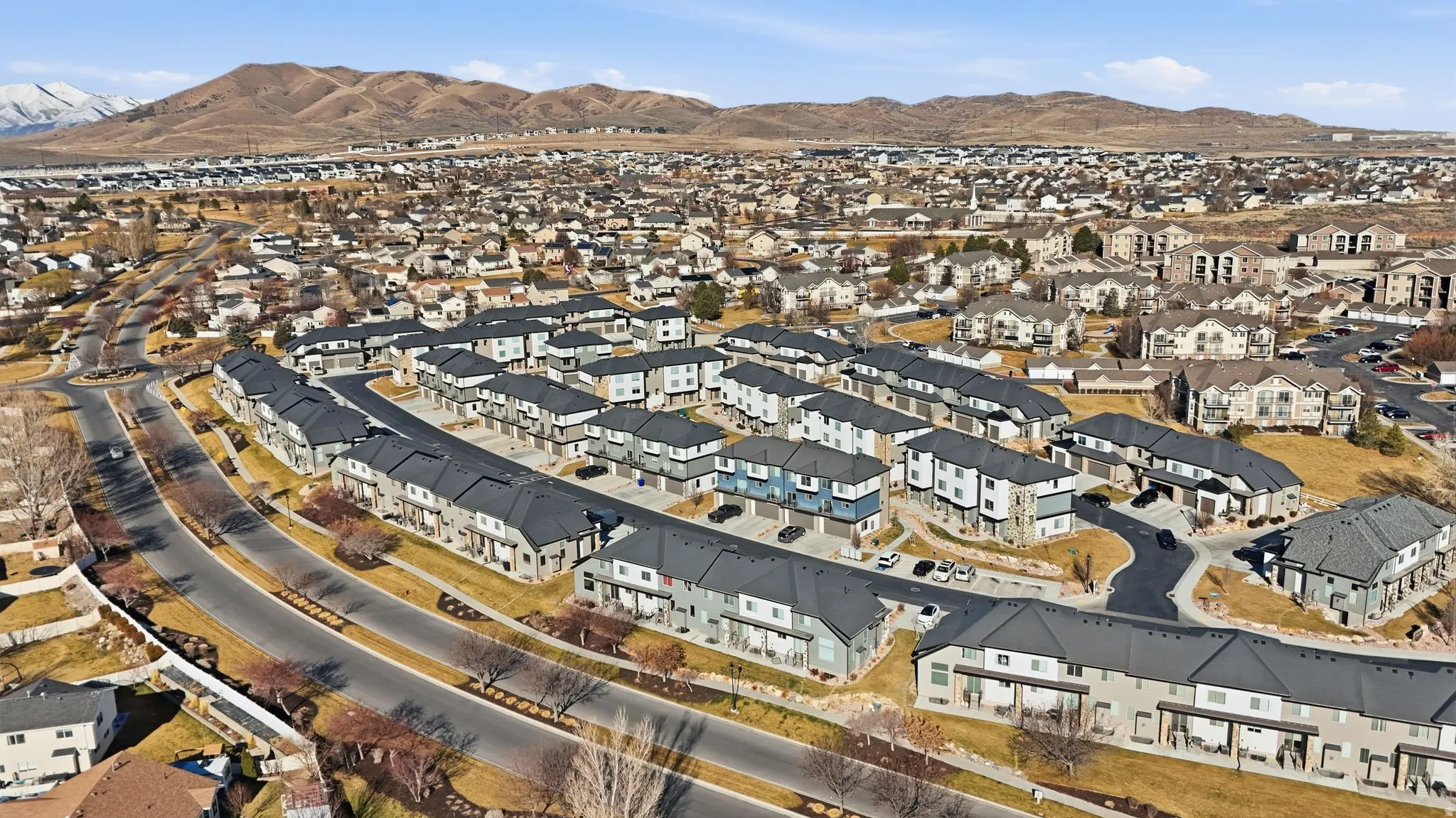 View of property location with a mountain backdrop and nearby suburban area