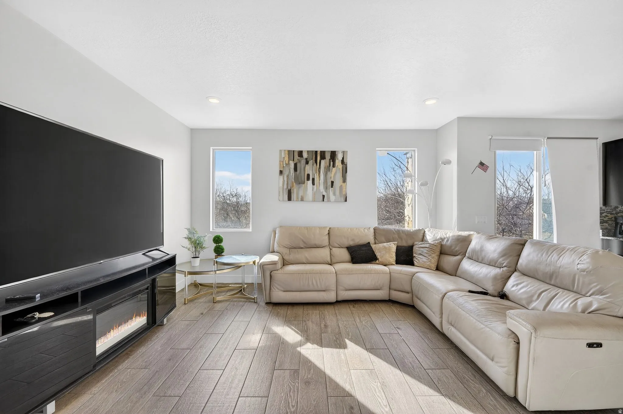 Living area with wood tiled floors and recessed lighting
