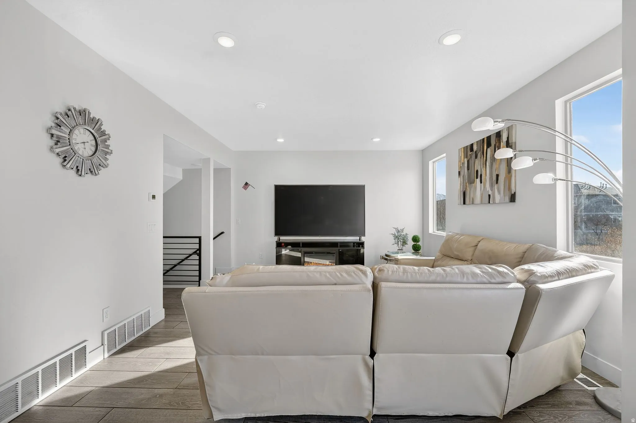 Living area featuring wood finish floors and recessed lighting