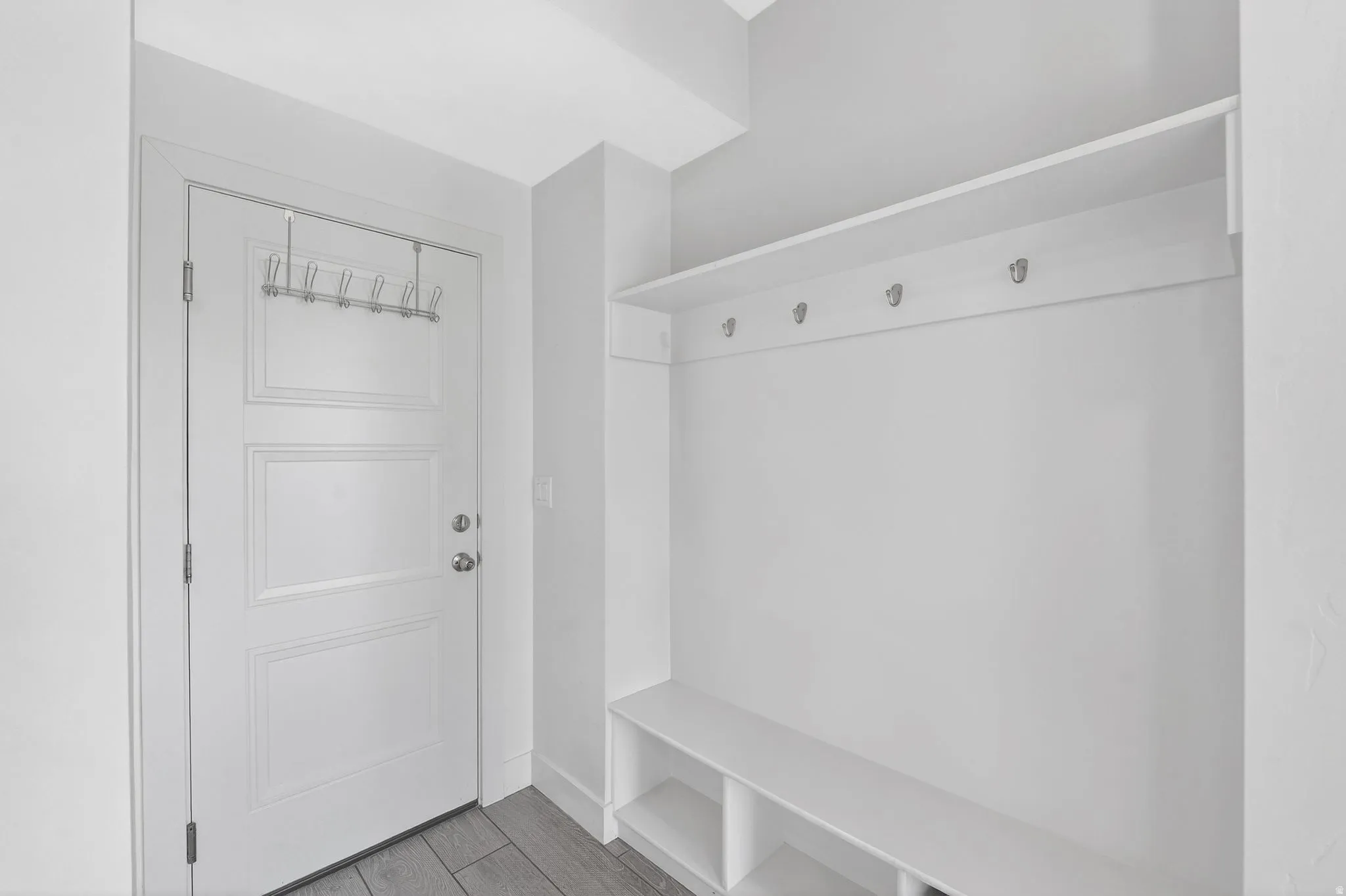 Mudroom featuring wood finished floors and baseboards