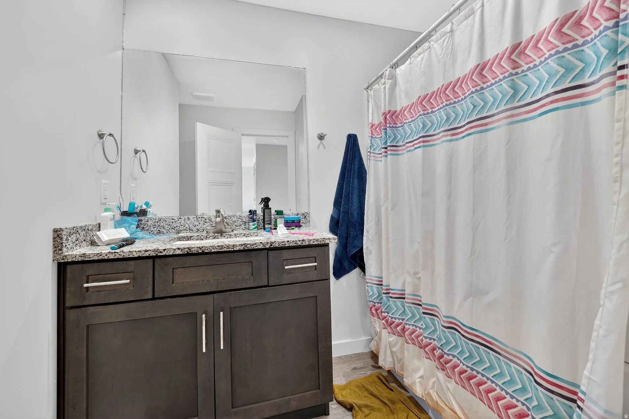 Full bath with vanity and light wood finished floors