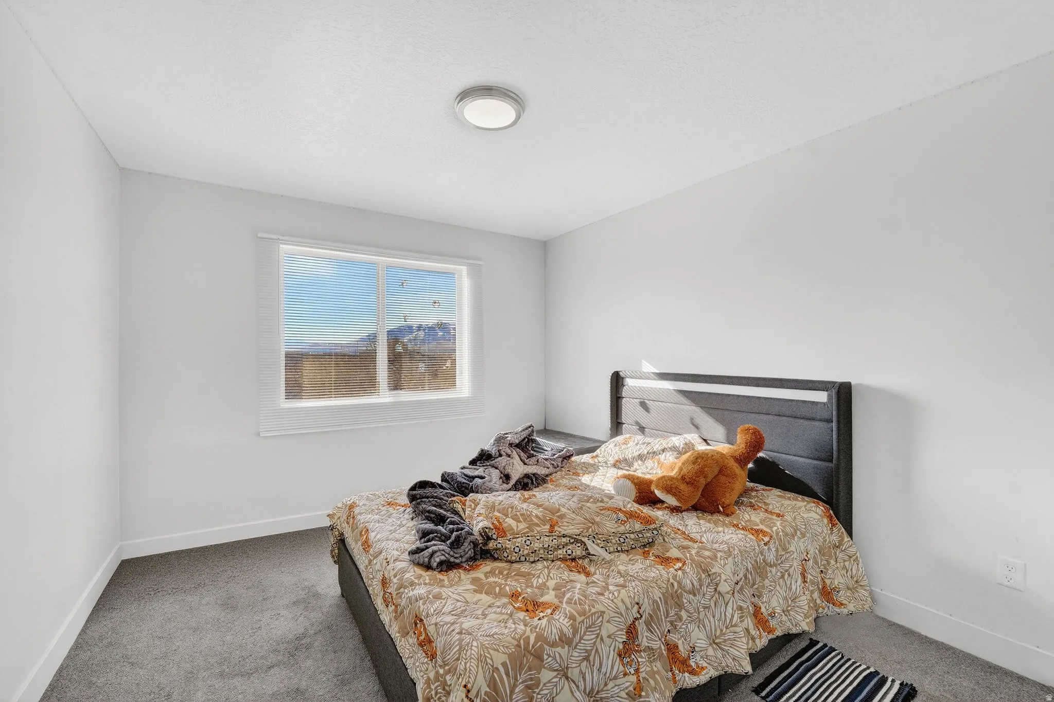 Carpeted bedroom with baseboards