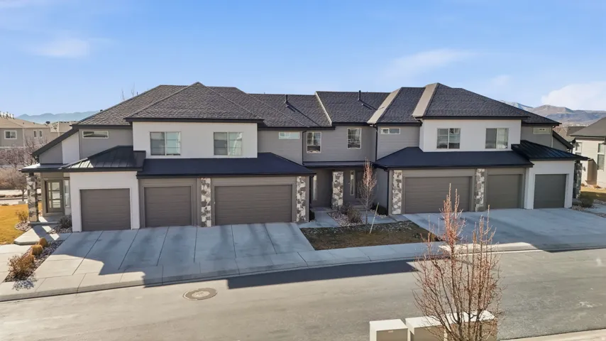 View of front of house featuring a standing seam roof, a mountain view, and stone siding