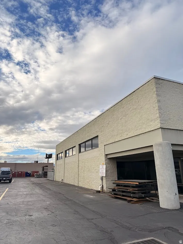 View of building exterior with uncovered parking