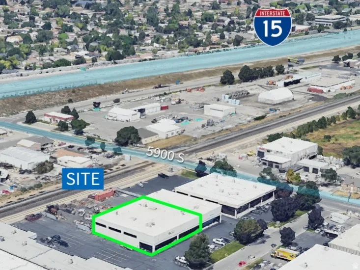 Aerial view of property and surrounding area with industrial structures and property boundaries highlighted