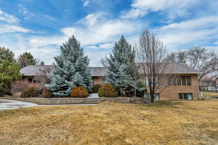 View of front of property with brick siding and a front lawn