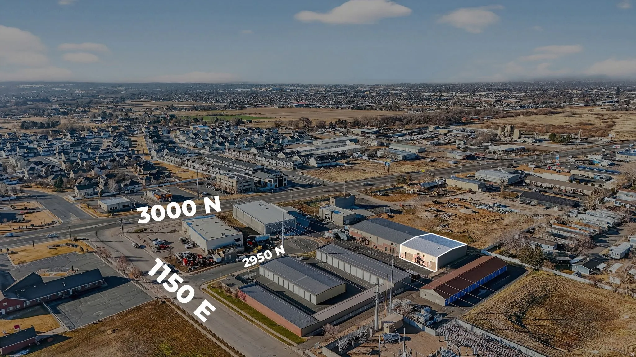 Aerial view of property's location with an industrial area