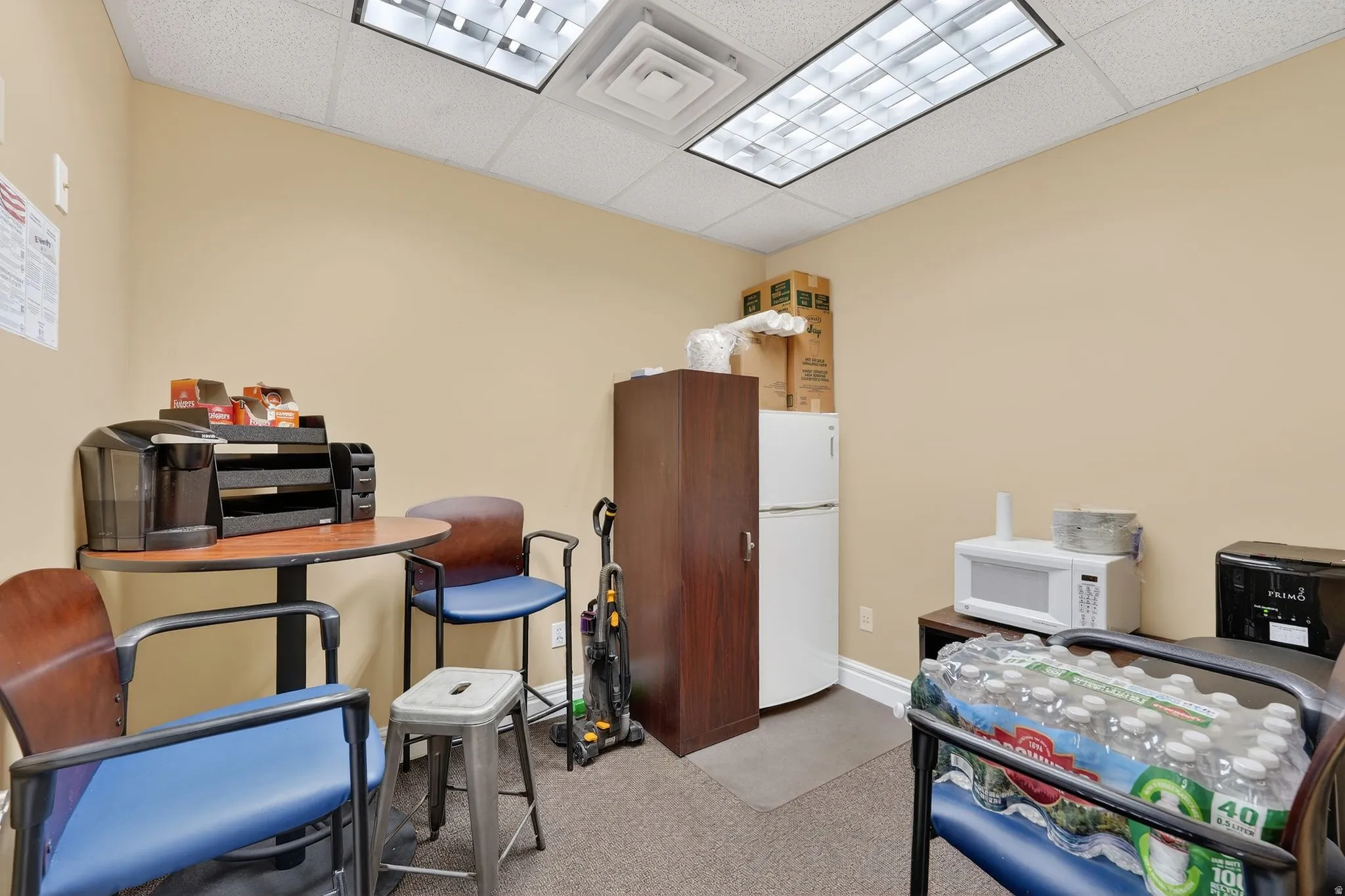 Office space featuring a paneled ceiling and light colored carpet