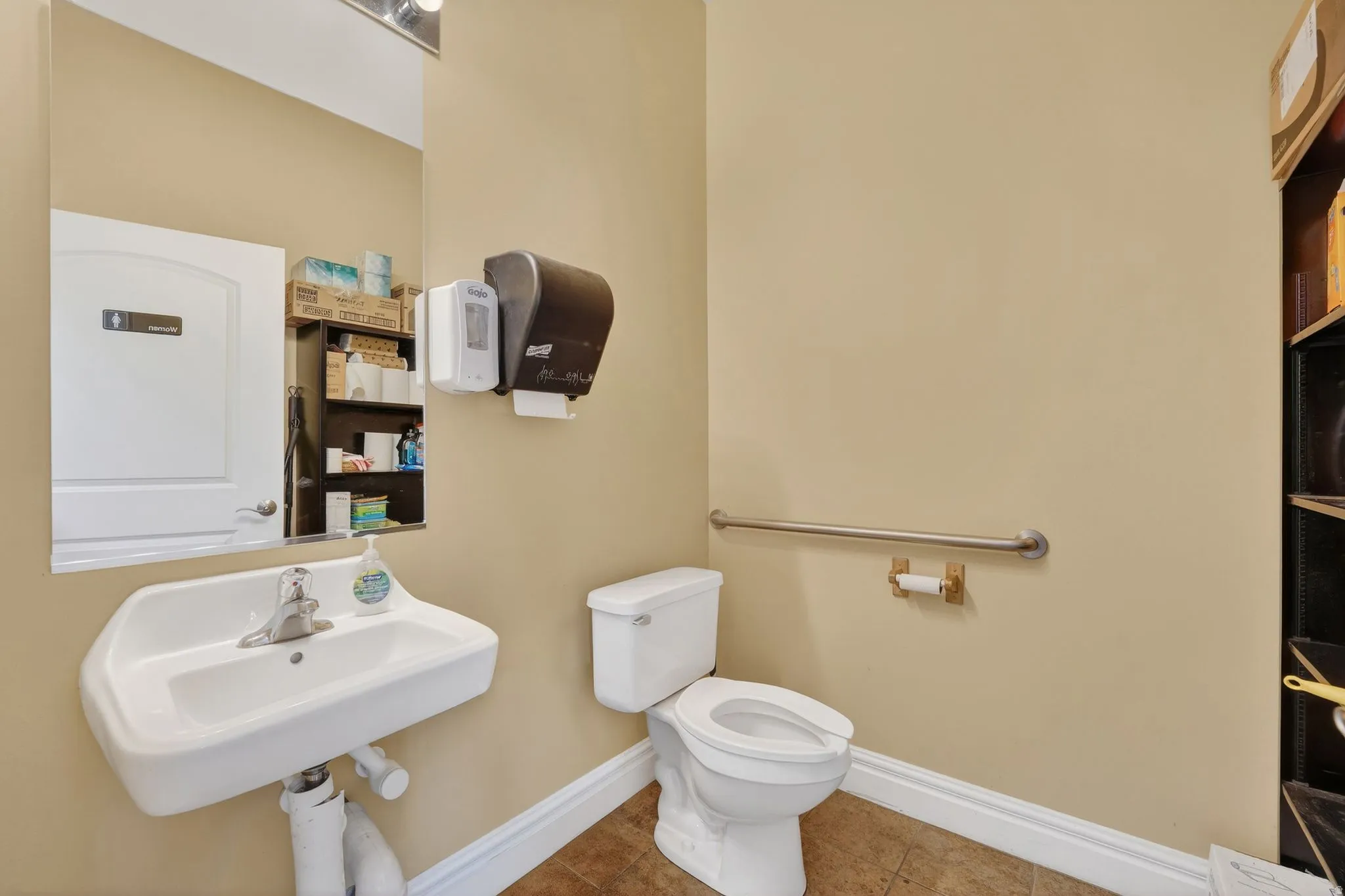 Bathroom featuring toilet and tile patterned flooring