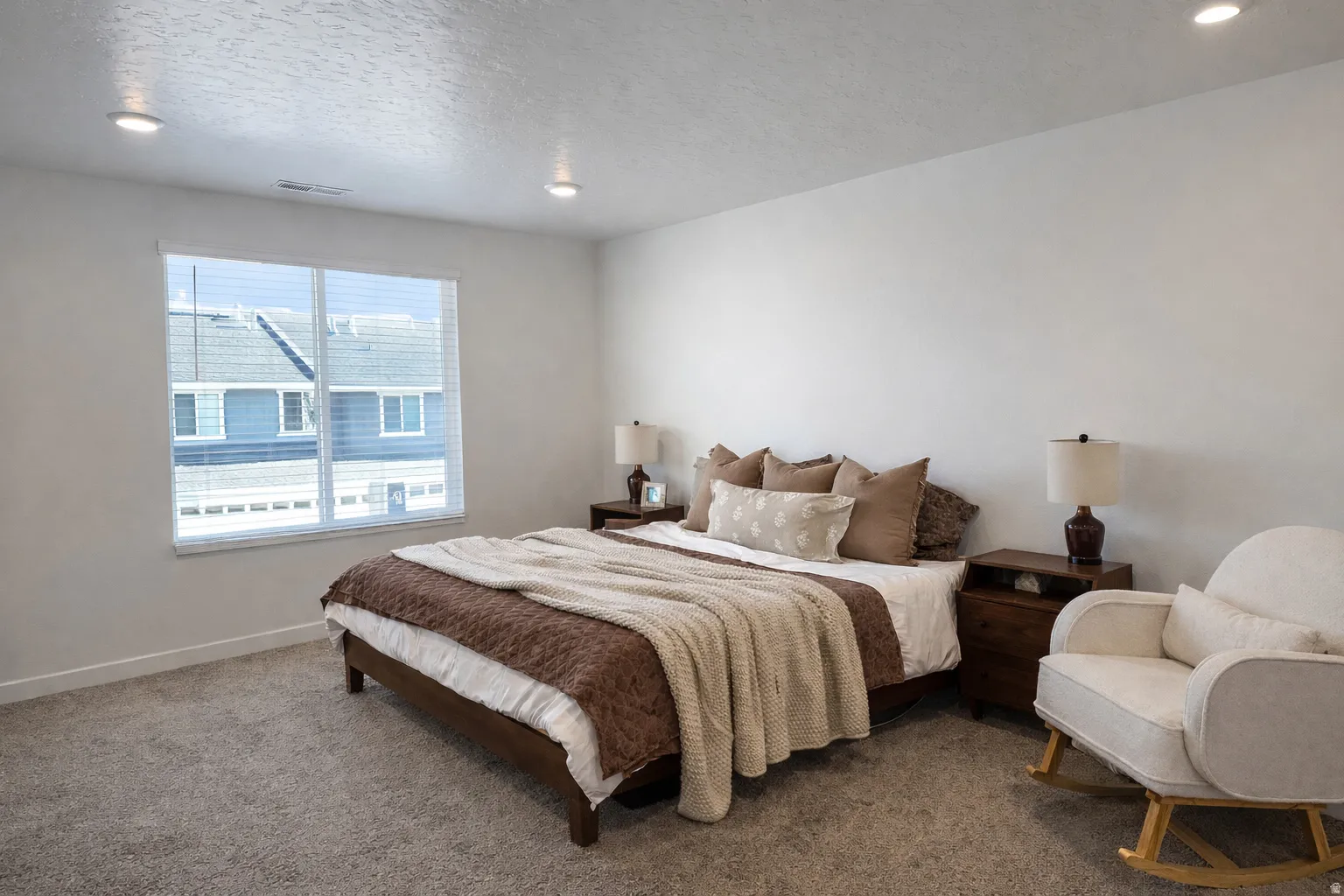 Bedroom featuring carpet floors, a textured ceiling, and recessed lighting
