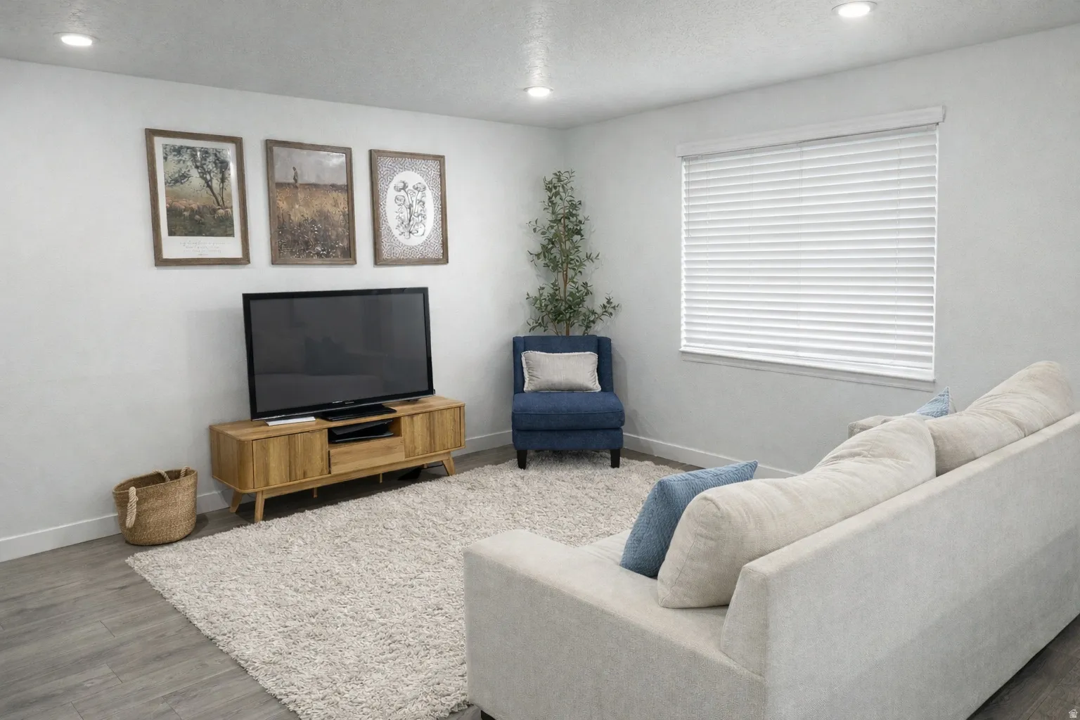 Living area featuring wood finished floors and recessed lighting
