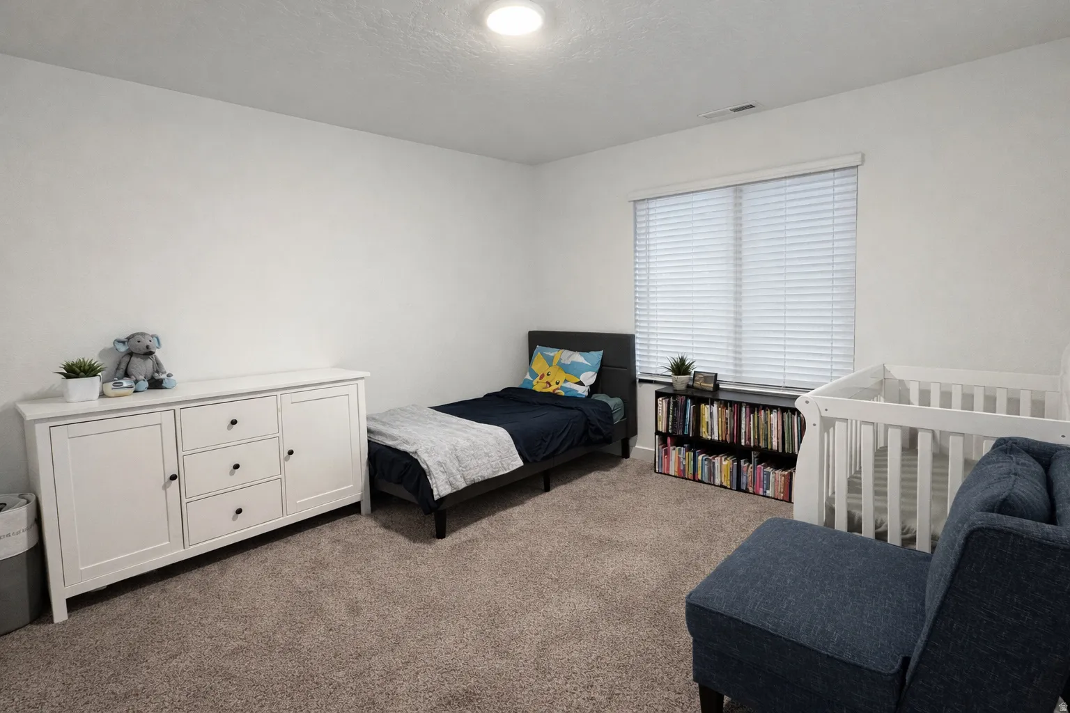 Carpeted bedroom featuring a textured ceiling