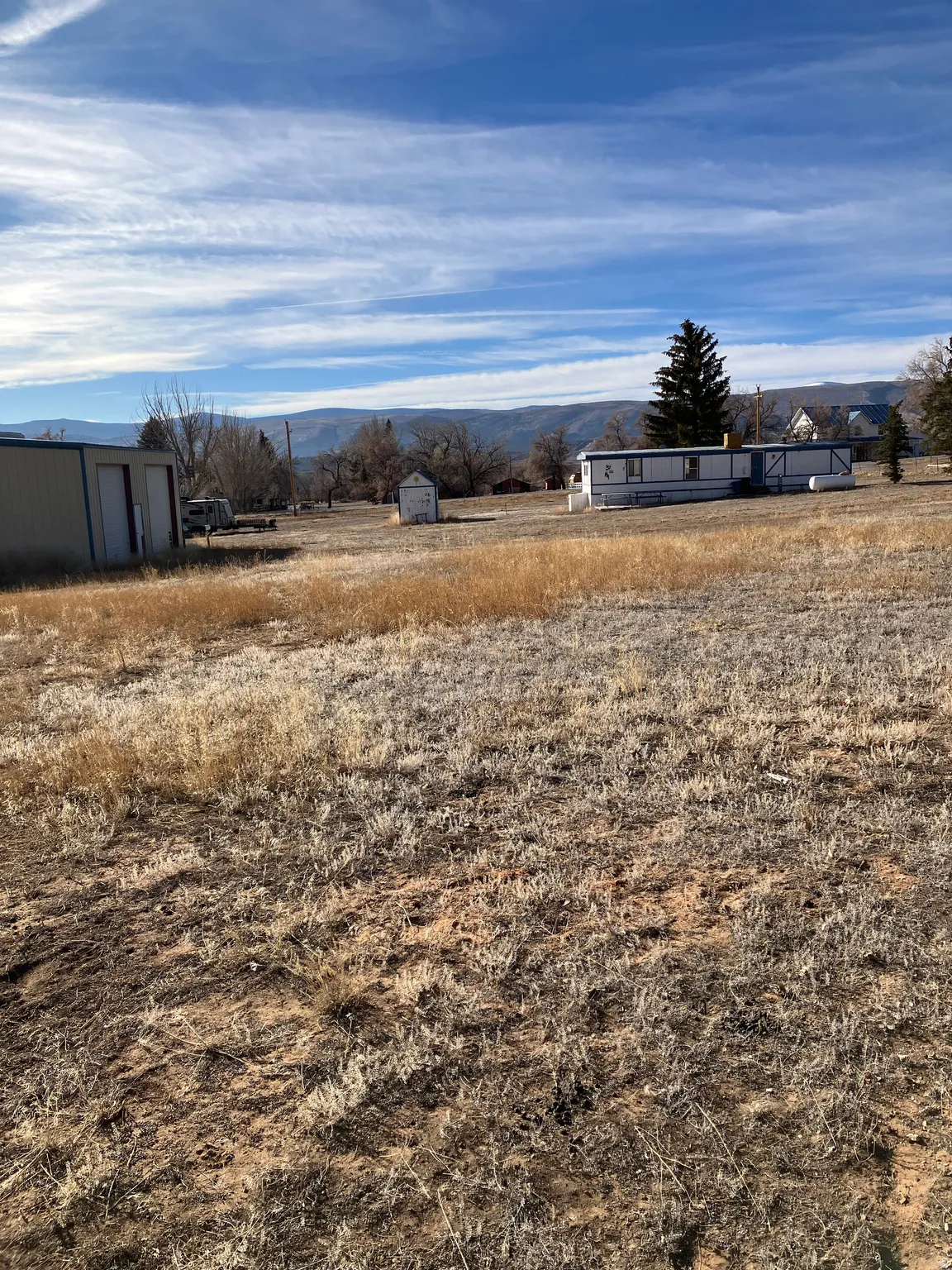 View of yard with a mountain view, an outdoor structure, and a rural view
