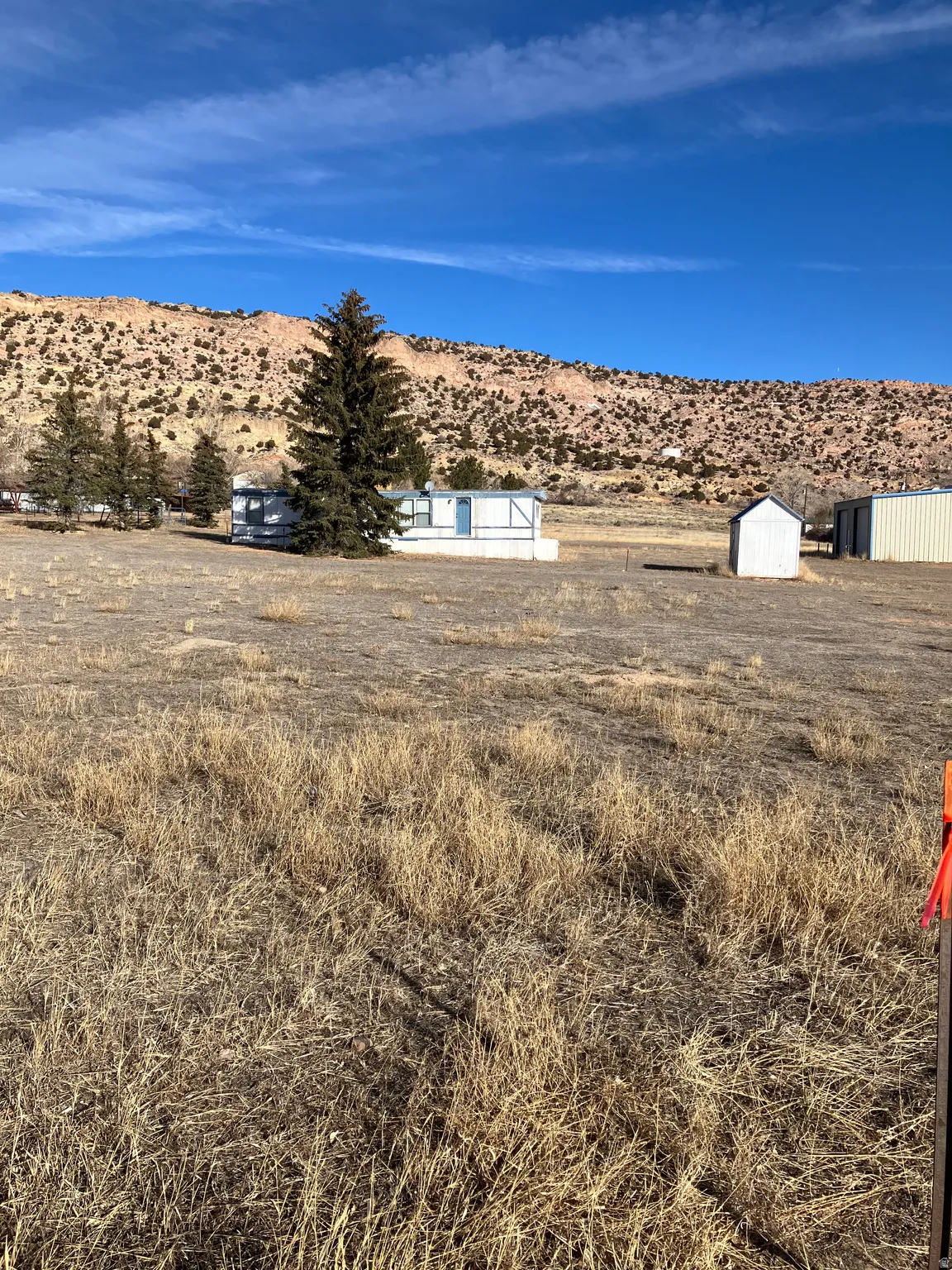 View of yard with a mountain view, a storage shed, and a rural view