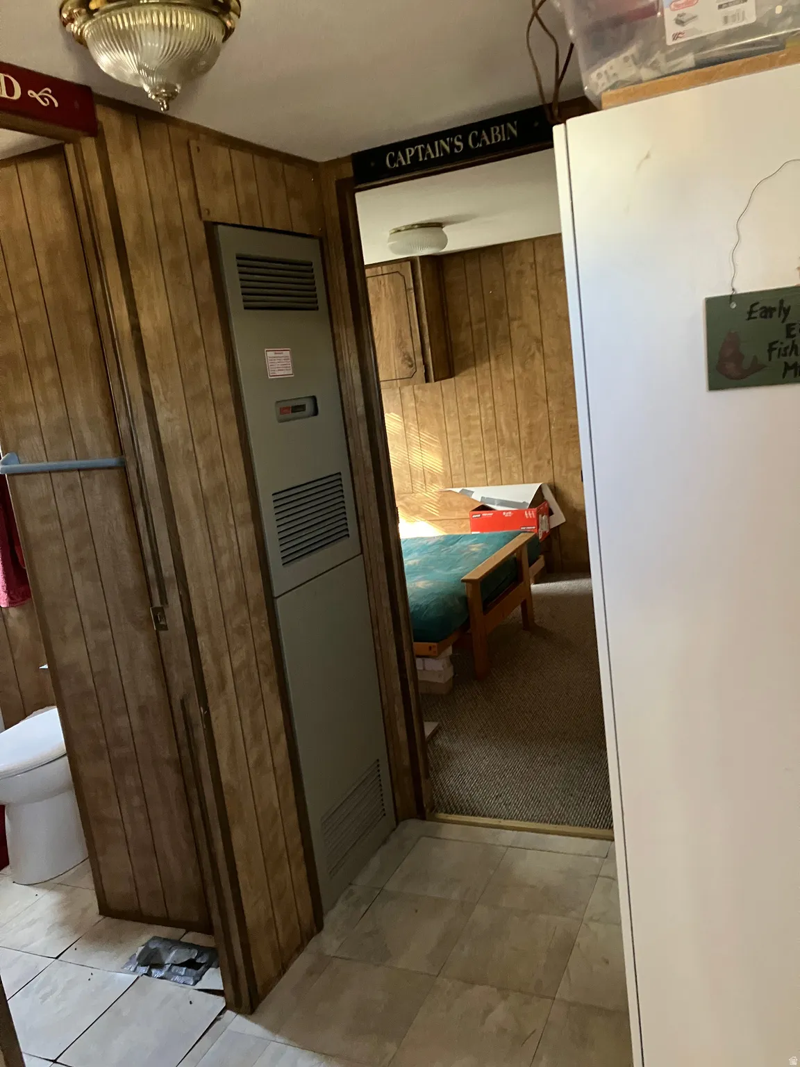 Corridor featuring wood walls and a heating unit