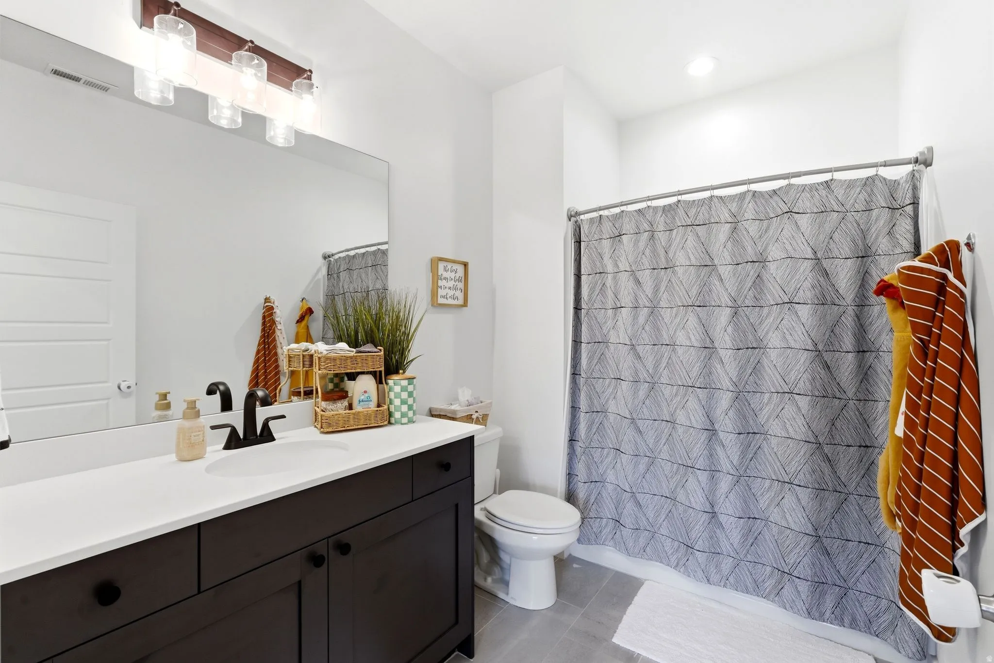 Full bath with vanity, light tile patterned flooring, and recessed lighting