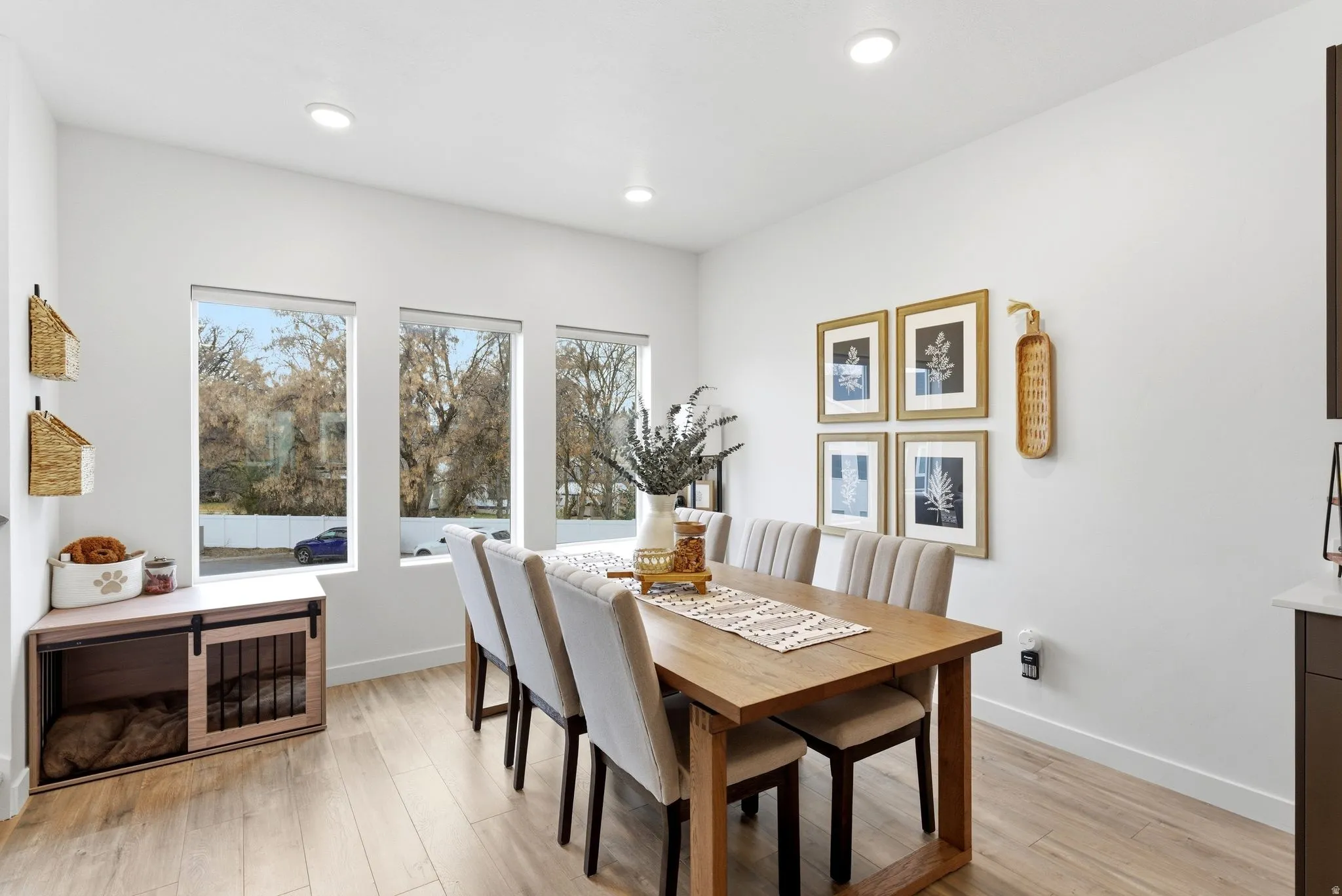 Dining area with light wood-style floors and recessed lighting