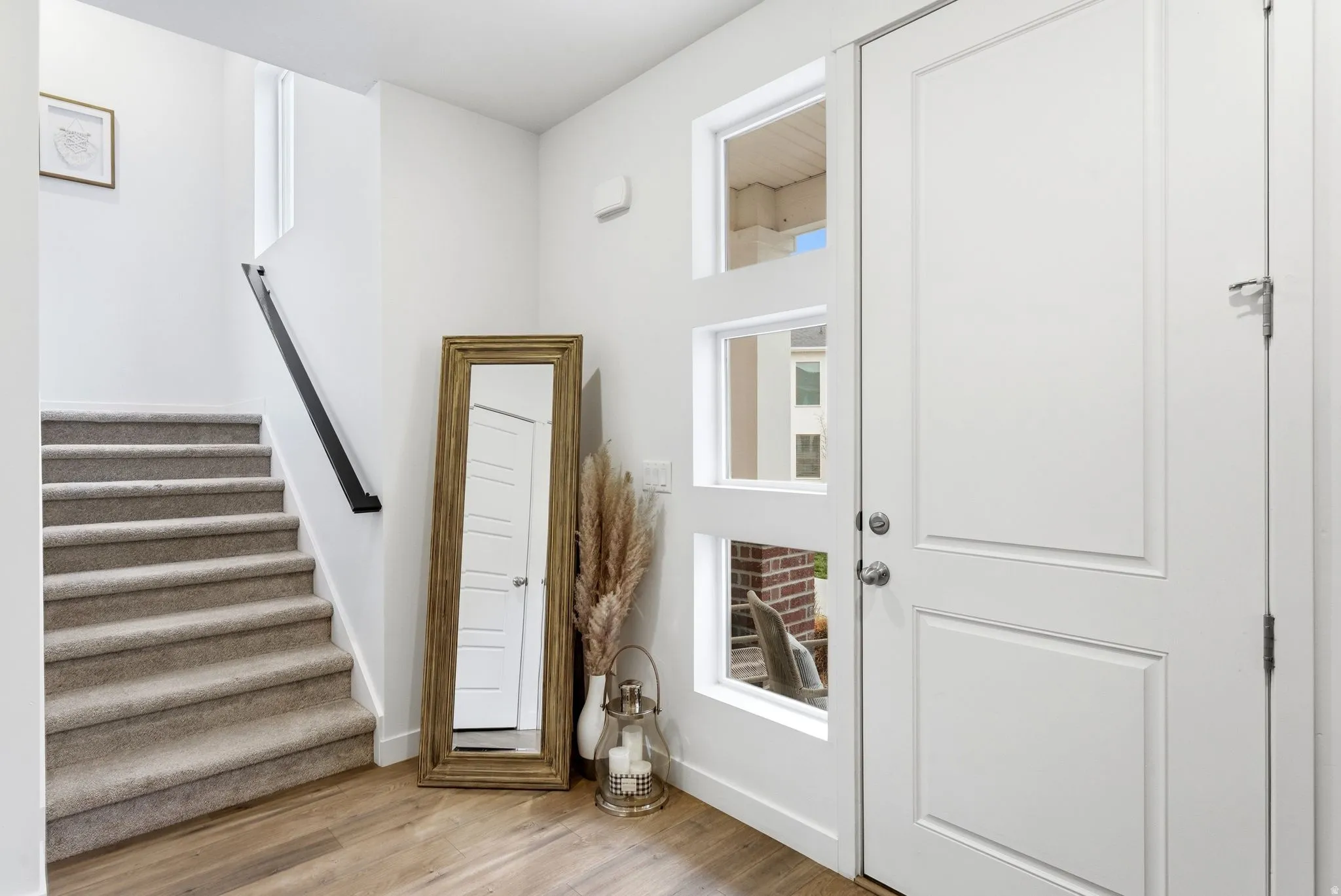 Entrance foyer with stairs and light wood finished floors
