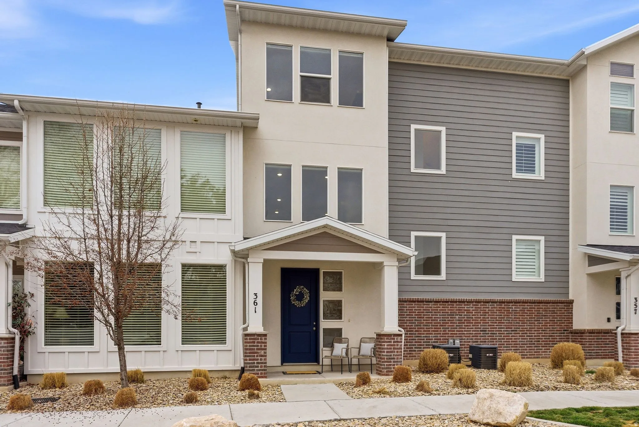 Modern home with brick siding and a porch