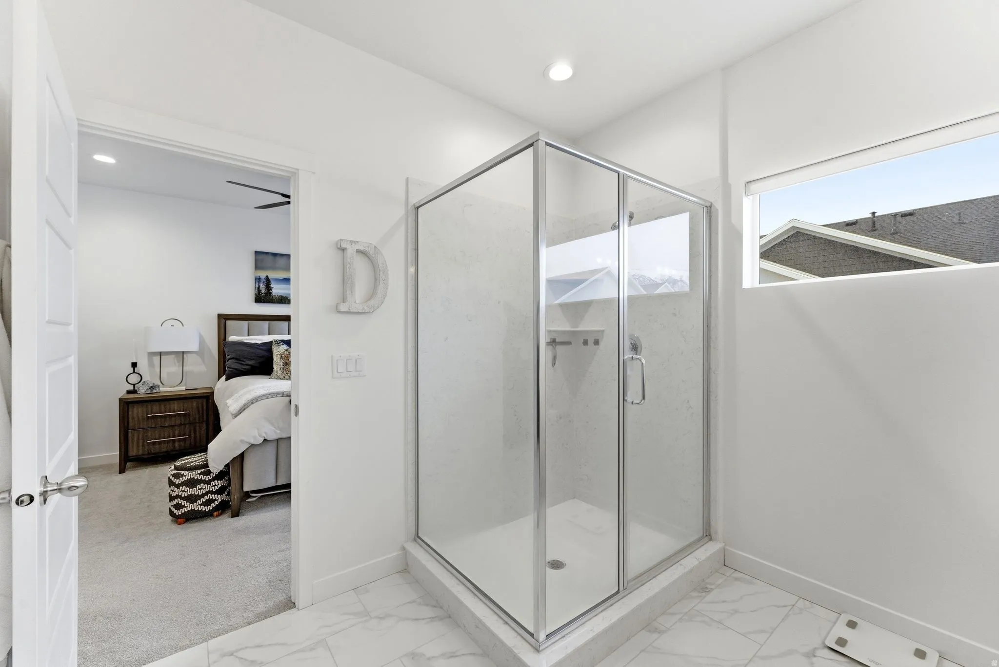 Ensuite bathroom with a shower stall, recessed lighting, and light marble finish flooring