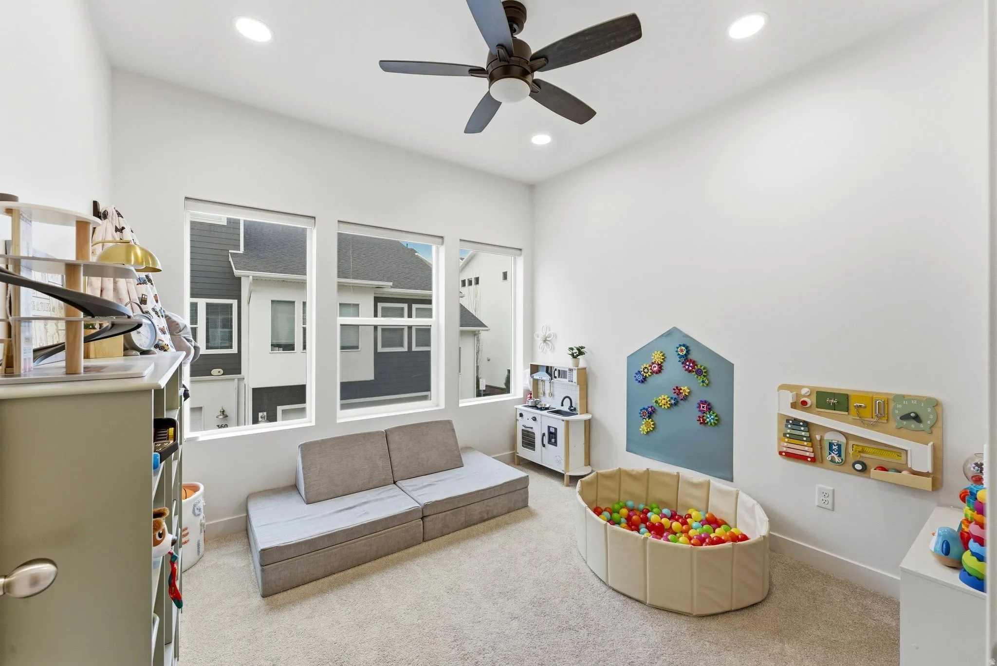 Recreation room featuring carpet floors, ceiling fan, and recessed lighting