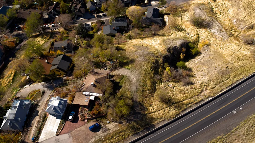 Aerial view of property and surrounding area with nearby suburban area
