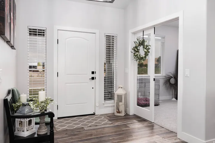 Entrance foyer with dark wood-type flooring and baseboards