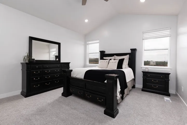 Bedroom with light carpet, recessed lighting, vaulted ceiling, and a ceiling fan