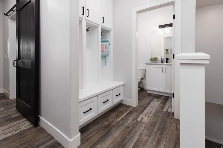 Mudroom with a barn door and dark wood-style flooring