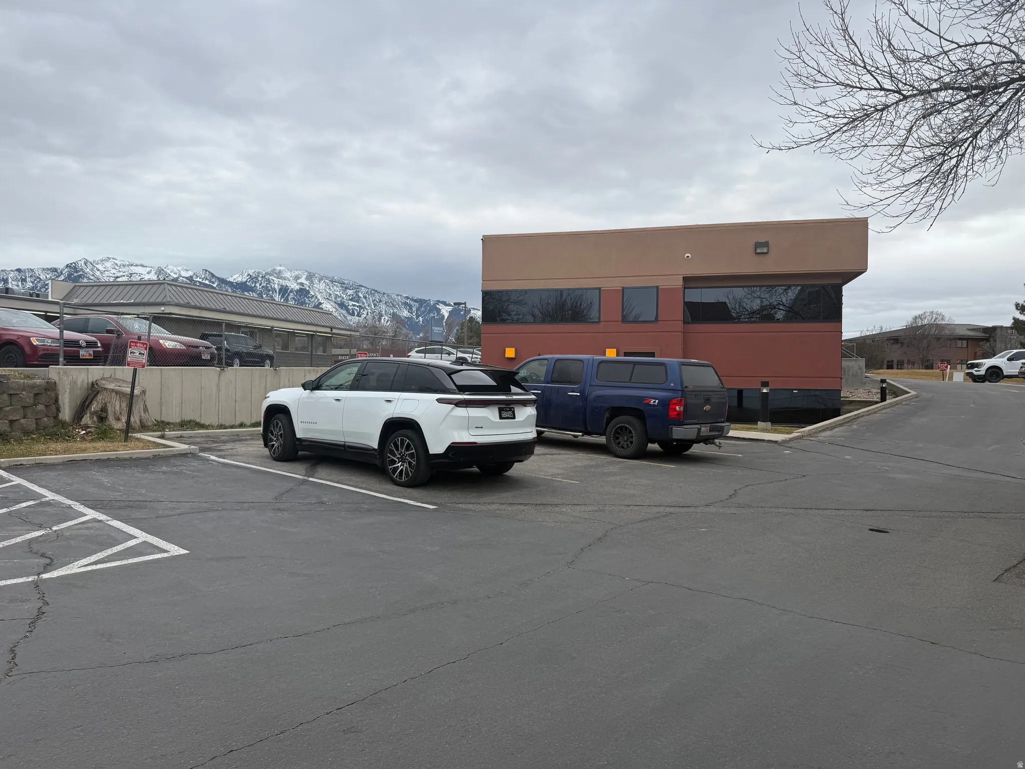 Uncovered parking lot featuring a mountain view