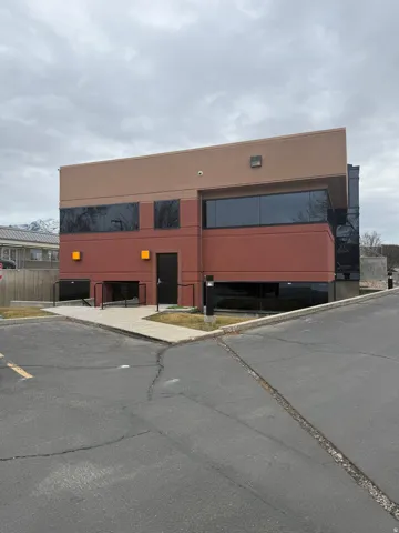 View of commercial property featuring uncovered parking
