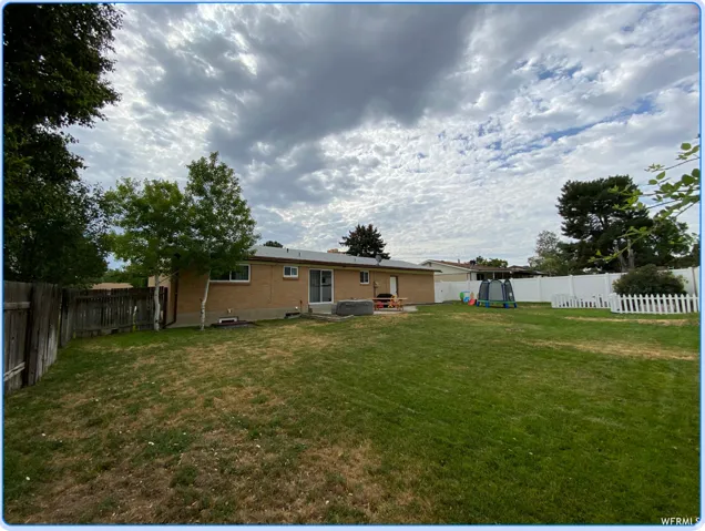 Back of house with a patio, a fenced backyard, and brick siding