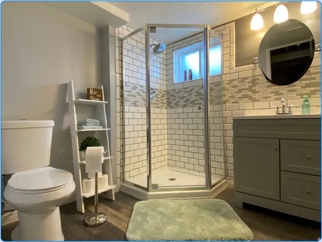Bathroom featuring dark wood finished floors, vanity, and a shower stall